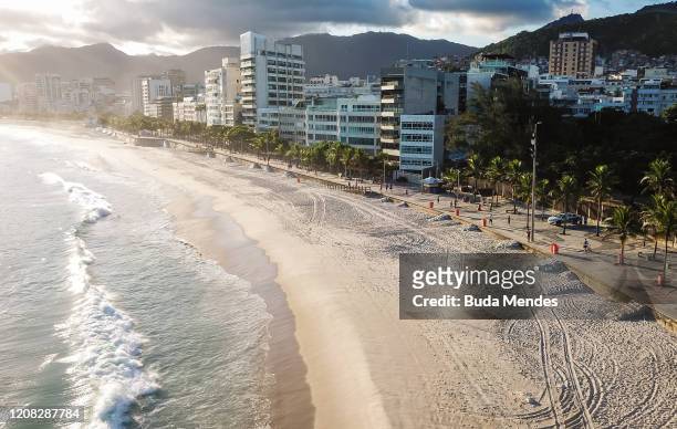 An aerial view of a near empty Arpoador beach on March 26, 2020 in Rio de Janeiro, Brazil. According to the Ministry of health, as today, Brazil has...