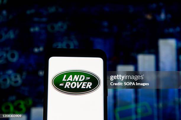 In this photo illustration a Land Rover logo seen displayed on a smartphone.