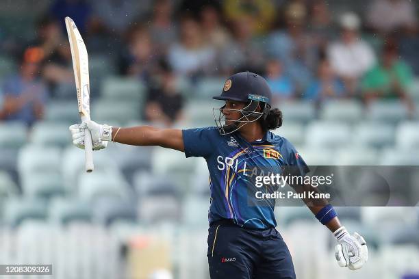 Chamari Athapaththu of Sri Lanka raises the bat to celebrate her half century during the ICC Women's T20 Cricket World Cup match between Australia...