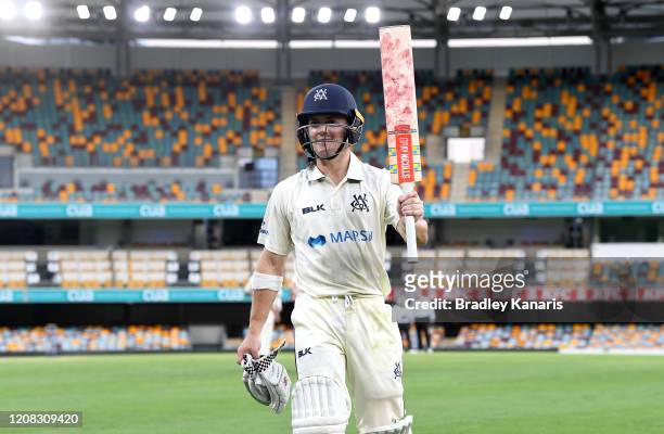 Seb Gotch of Victoria celebrates and acknowledges the fans after scoring a century during day one of the Sheffield Shield match between Queensland...