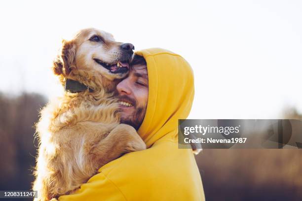 man and dog enjoying sunny day in nature - leaflitter stock pictures, royalty-free photos & images