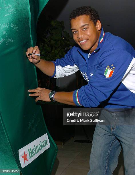 Robert Ri'chard signs the Heineken green ribbon in the Heineken Suites at the Le Meridian