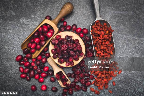 delicious wild cranberries and goji berries - wolfberry stock pictures, royalty-free photos & images