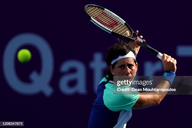 Carla Suarez Navarro of Spain returns a backhand against Zhang Shuai of China during Day 2 of the WTA Qatar Total Open 2020 at Khalifa International...