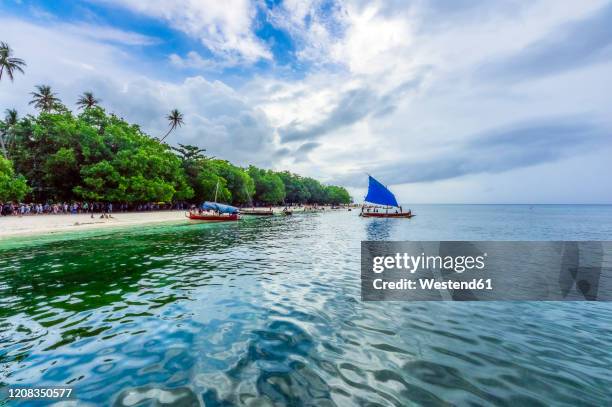 papua new guinea, trobriand islands, kitava island, beach with tourists and boats - papua new guinea beach stock pictures, royalty-free photos & images