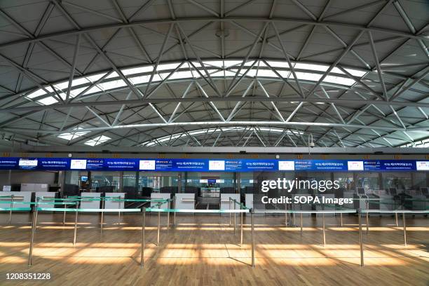 The departure counters are pictured empty. Number of Incheon Airport passengers falls to record low amid coronavirus spread.