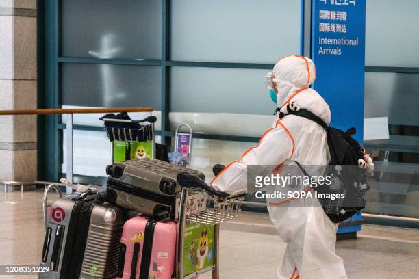 Passenger wearing a protective suit seen at the arrival hall. Number of Incheon Airport passengers falls to record low amid coronavirus spread.