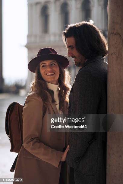 happy young couple visiting the city of venice, italy - venice couple foto e immagini stock