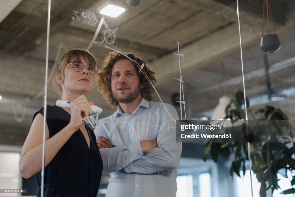 Businessman and businesswoman working on a project in office