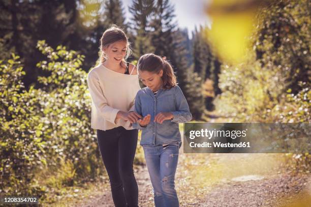 two sisters walking on forest path - lane sisters stockfoto's en -beelden