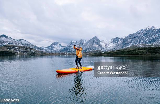 woman stand up paddle surfing, leon, spain - león province spain stock pictures, royalty-free photos & images