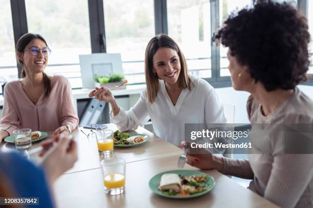 businesswomen during lunch in an office - lunch stock-fotos und bilder