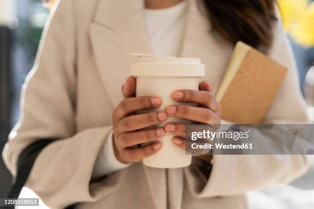 close-up of woman holding takeaway coffee - cream colored purse stock pictures, royalty-free photos & images