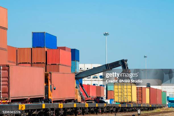 crane loading container box to logistics truck for exports in container port - docklands studio stock pictures, royalty-free photos & images