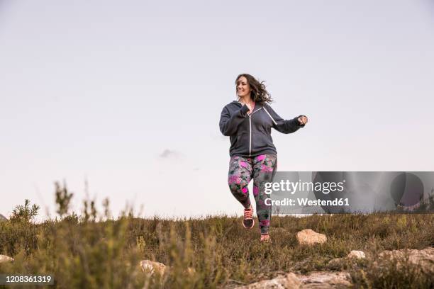 plus-size-model jogging in the countryside - plus size model fitness stock pictures, royalty-free photos & images