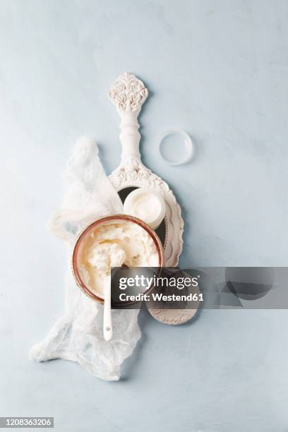 gauze, hand mirror and bowl of homemade shea butter moisturizer - shea butter stock pictures, royalty-free photos & images