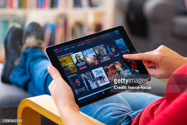 online streaming with tablet pc - mood stream stock pictures, royalty-free photos & images