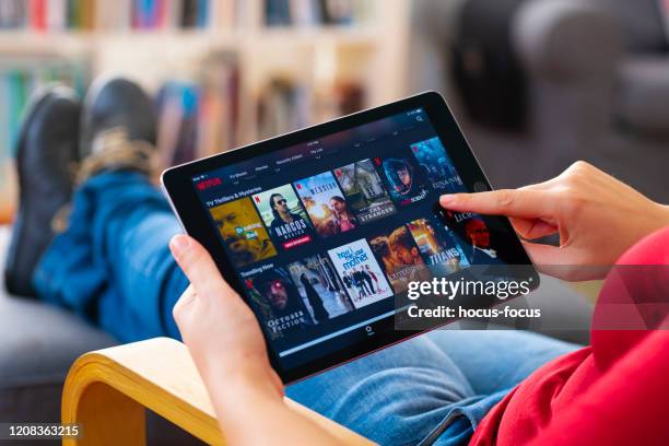 online streaming with tablet pc - tv program stock pictures, royalty-free photos & images