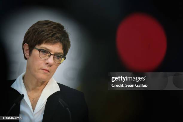 German Christian Democrats leader Annegret Kramp-Karrenbauer, seen between reporters and television camera, speaks to the media after a meeting of...