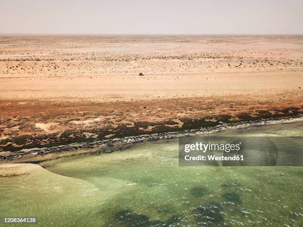 mauritanie, banc darguin national park, aerial view of car crossing sahara desert near to the atlantic ocean shore - mauritania stock pictures, royalty-free photos & images