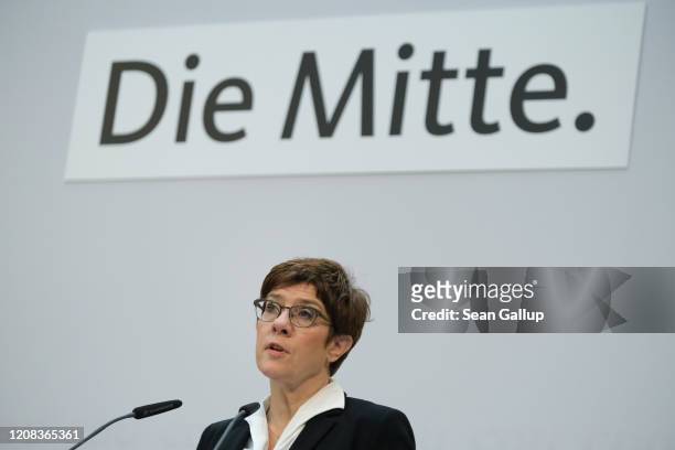 German Christian Democrats leader Annegret Kramp-Karrenbauer speaks to the media under a sign that reads: "The Middle" after a meeting of the CDU...