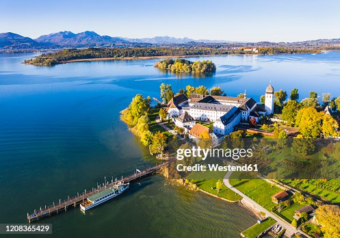 Germany, Bavaria, Aerial view of pier and monastery on Frauenchiemsee islet