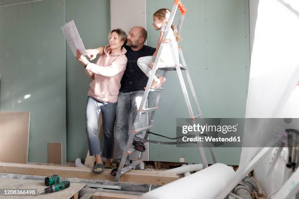 family on construction site at home studying plan - foundation for kids stock pictures, royalty-free photos & images