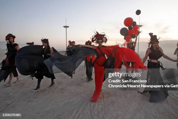 Performing artists dance on the playa during a dust storm at the Burning Man festival in Black Rock City., NV on September 4, 2009.