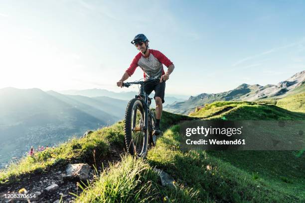 mountainbiker on a way in grisons, switzerland - velofahren stock-fotos und bilder
