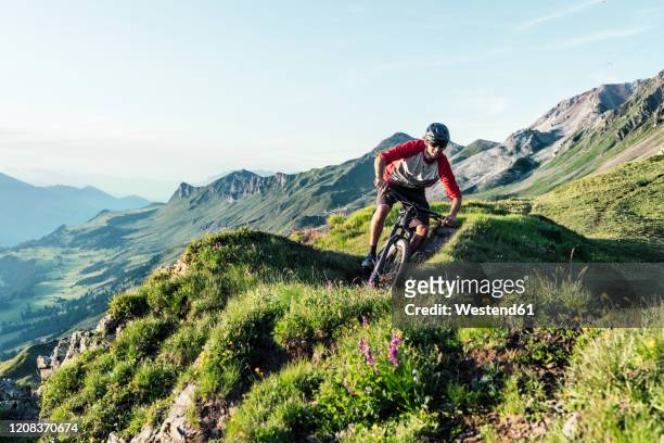 mountainbiker on a way in grisons, switzerland - graubunden canton stock pictures, royalty-free photos & images