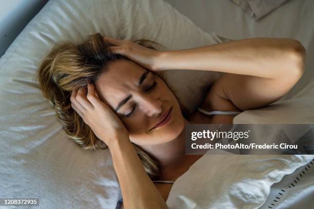 young woman sleeping on bed - beautiful woman sleeping stock pictures, royalty-free photos & images