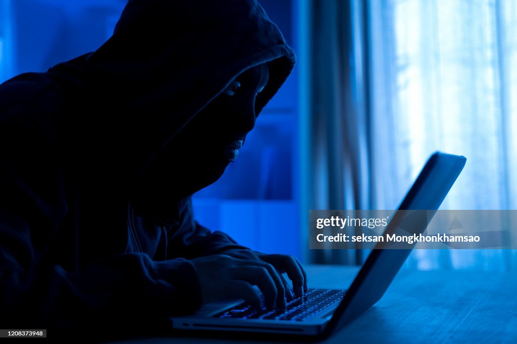 Cyber Attack Hacker using computer with code on interface digital dark background. Security System and Internet crime concept.