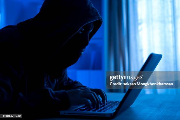 cyber attack hacker using computer with code on interface digital dark background. security system and internet crime concept. - spy background stock pictures, royalty-free photos & images