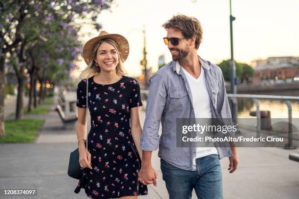 couple walking on street - young couple fotografías e imágenes de stock