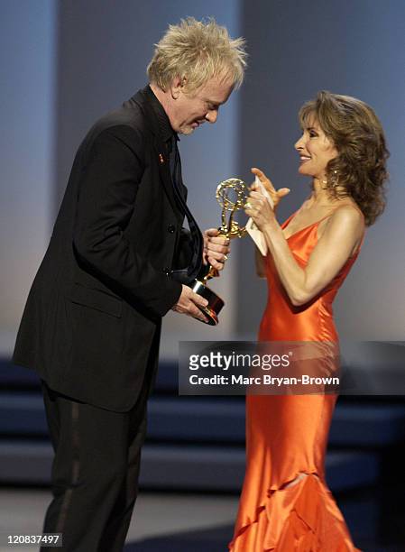 Anthony Geary accepts the award for Outstanding Lead Actor in a Drama Series for his role in "General Hospital." from presenter Susan Lucci.
