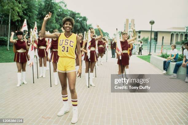 American basketball player Cheryl Miller#31 of USC Trojans followed by a squad of cheerleaders, circa 1984.