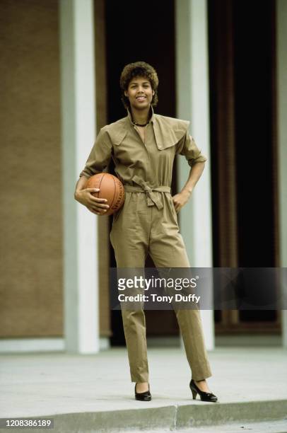 American basketball player Cheryl Miller of USC Trojans, wearing a jumpsuit as she poses with a basketball, October 1983.