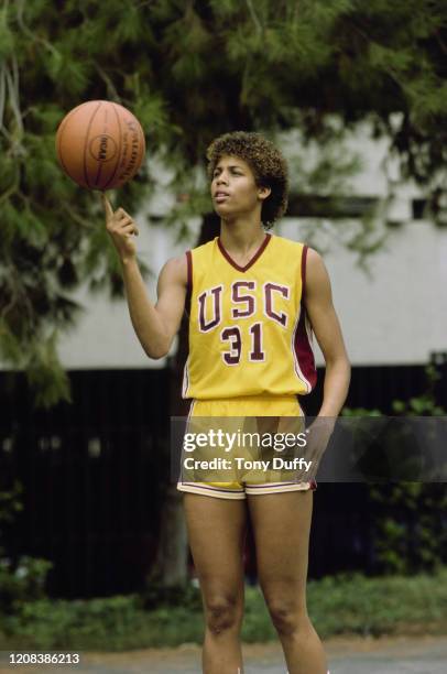 American basketball player Cheryl Miller of USC Trojans, balancing a basketball on her index finger, October 1983.