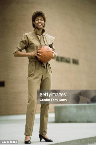 American basketball player Cheryl Miller of USC Trojans, wearing a jumpsuit as she poses with a basketball, October 1983.