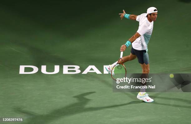Malek Jaziri of Tunisia plays a backhand against Novak Djokovic of Serbia during his men's singles match on Day Eight of the Dubai Duty Free Tennis...