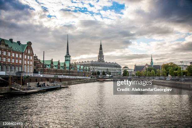 copenhagen canal pier and stock exchange buildings - copenhagen skyline stock pictures, royalty-free photos & images