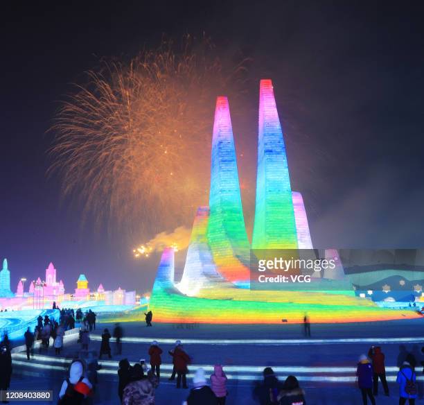 Fireworks explode over illuminated ice sculptures during opening ceremony of the 36th Harbin International Ice and Snow Festival at the Harbin Ice...