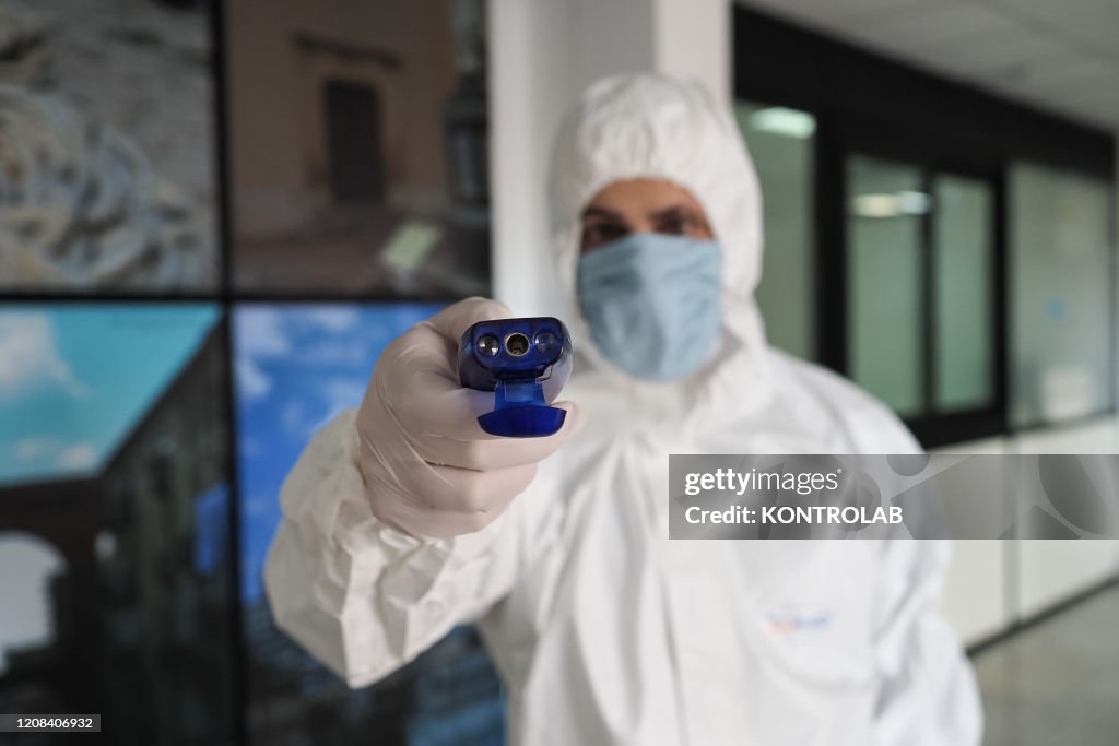 A nurse shows how one of the digital thermometers that is...