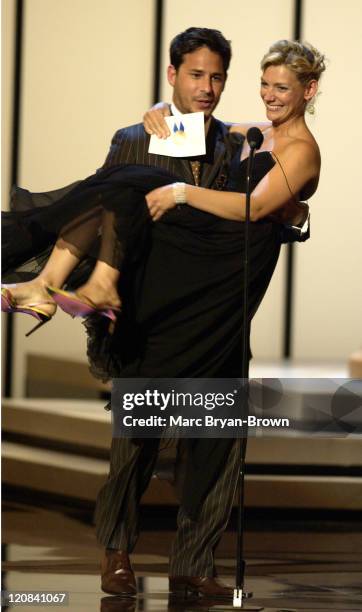 Ricky Paull Goldin carries Beth Ehlers as they present the award for potstanding Performer in a Children's/Youth/Family Special.