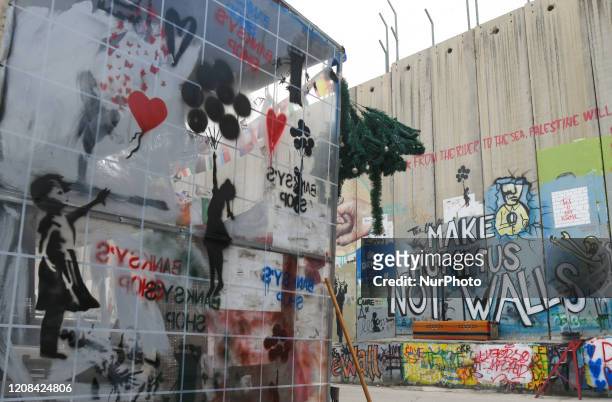 Political and social mural paintings and posters on the wall in Bethlehem. On Thursday, March 5 in Bethlehem, Palestine