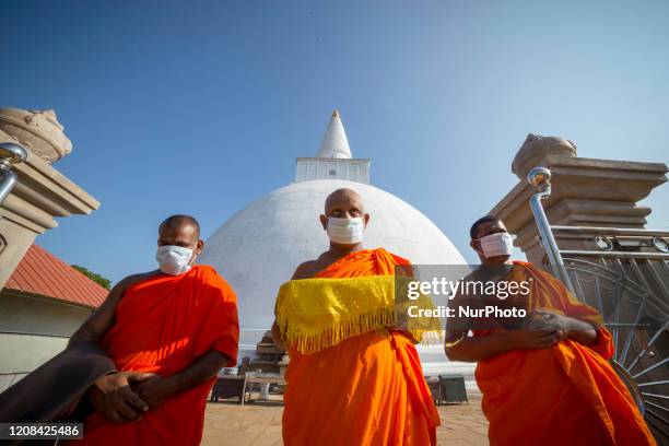 Sri Lankan Buddhist monks wearing protective face masks perform rituals to invoke blessings for the Covid-19 patients around the world and for...