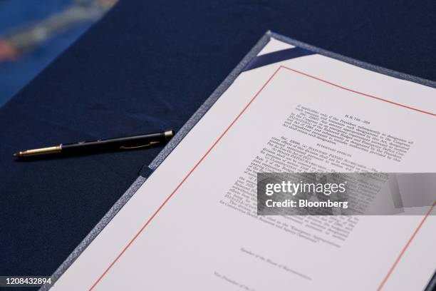 Copy of H.R. 748, Coronavirus Aid, Relief, and Economic Security Act, sits on a table before a signing ceremony at the U.S. Capitol in Washington,...