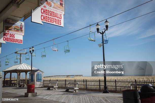 Amusement rides sit idle above an empty boardwalk in Seaside Heights, New Jersey, U.S., on Friday, March 26, 2020. New Jersey now has 8,825 positive...