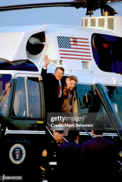 President Ronald Reagan and First Lady Nancy Reagan wave from the doorway of Marine One as they prepare to depart the White House South Lawn enroute...