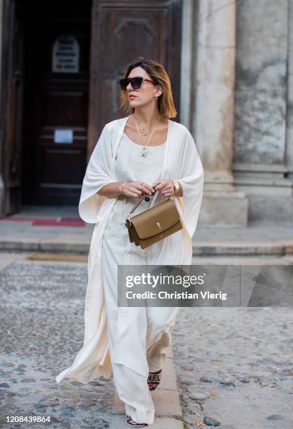 Aylin Koenig is seen wearing Bally bag, white kimono, pants, top during Milan Fashion Week Fall/Winter 2020-2021 on February 22, 2020 in Milan, Italy.